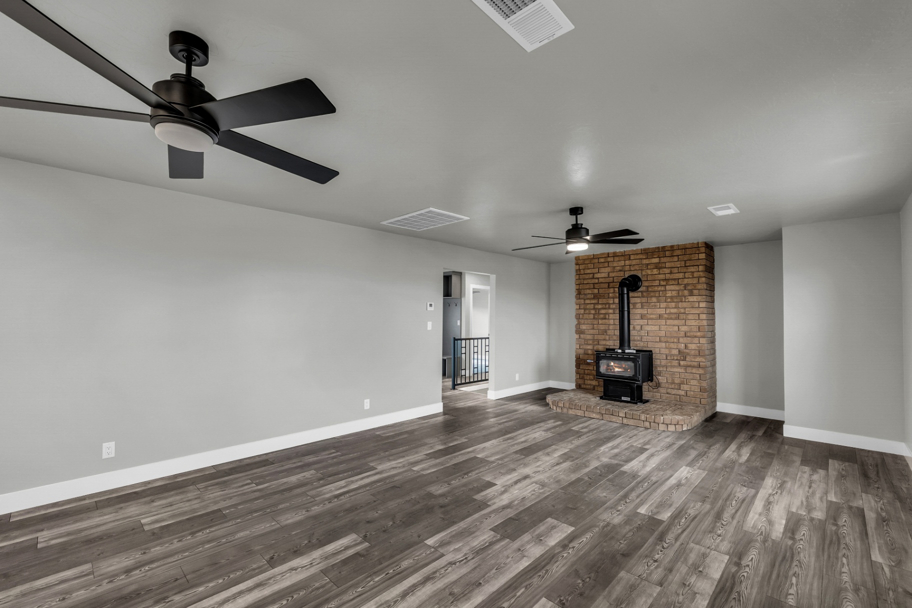 Warm finished living room with fireplace by Prestigious
