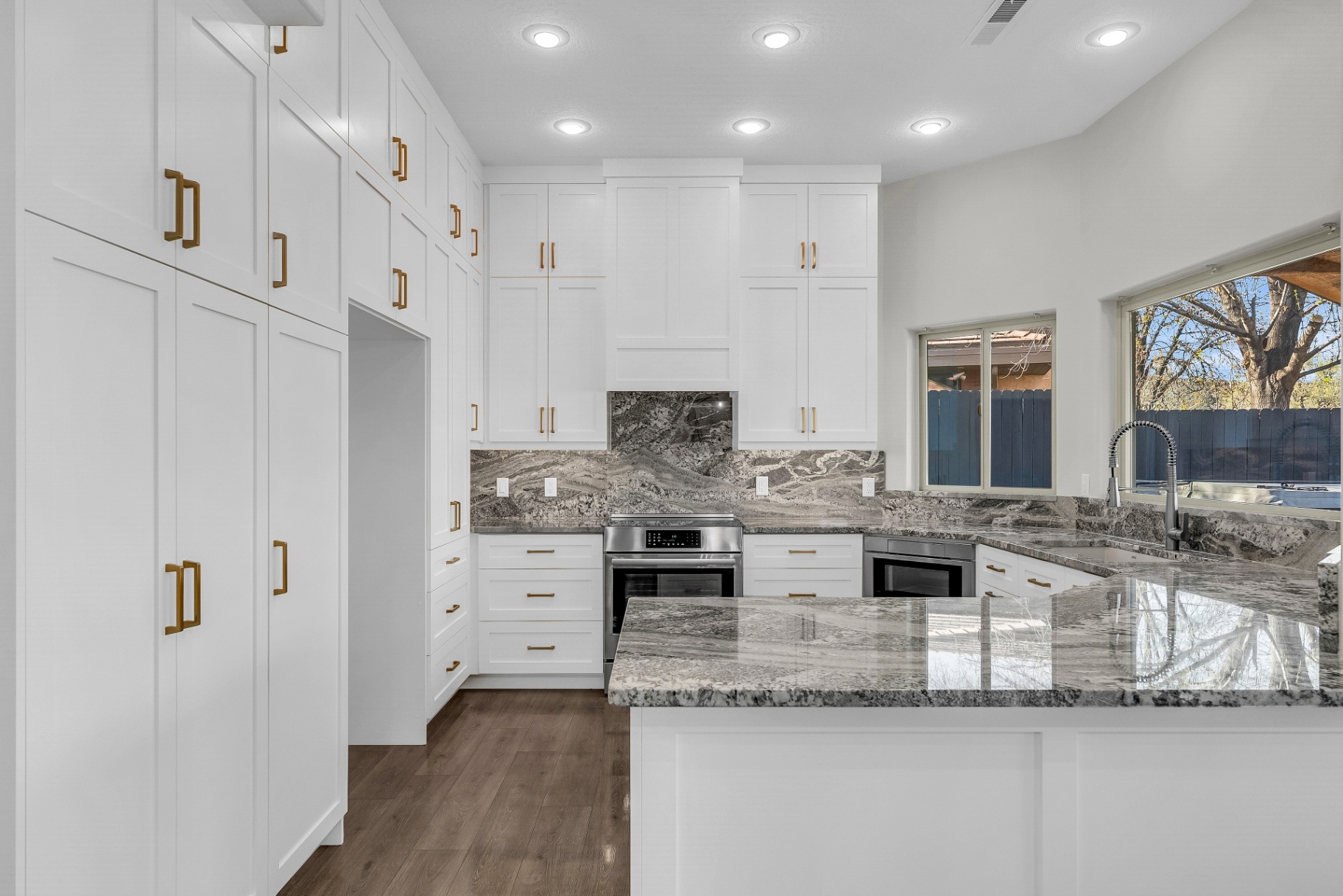 Completed Prestigious kitchen with custom cabinetry and gold fixtures